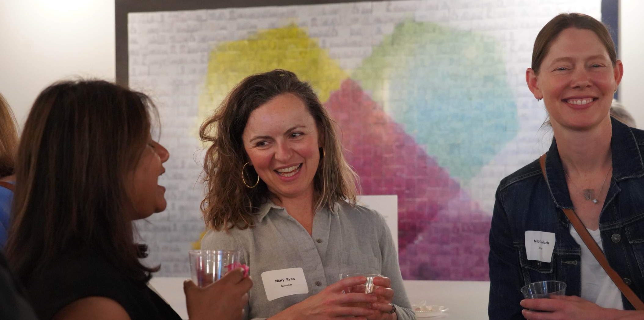 three laughing young women at an event